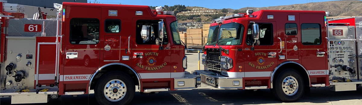 Fire Trucks in front of Sign Hill