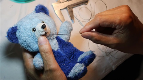 Image of teddy bear getting repaired